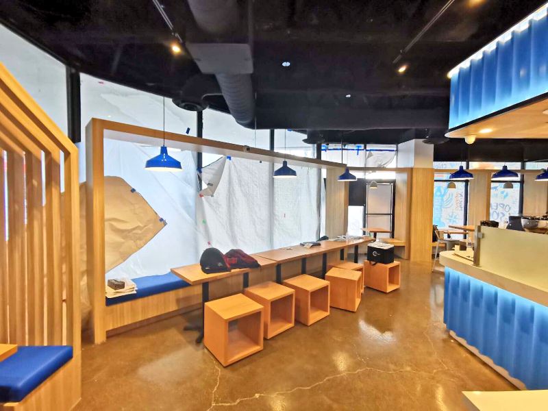 Window bench seating with wood cube stools and blue pendant lights