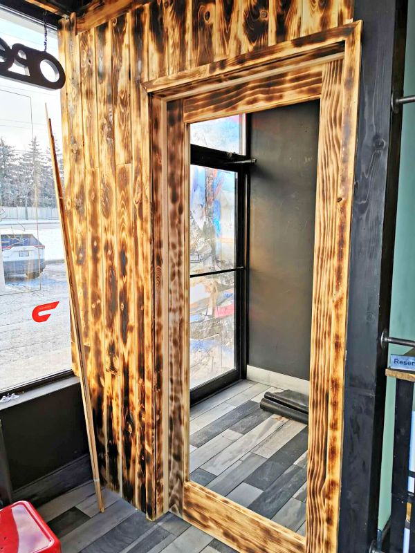 Charred wood wall cladding and door casing at a restaurant entrance