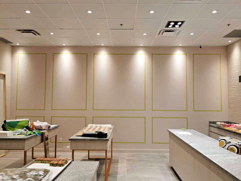 Shop wall marked out for panel moulding above granite counters